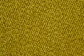 Texture of thick, strong mustard color fabric shot close-up