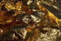 Texture of a thin crumpled sheet of foil. Crumpled foil background. Stock photo foil. Gold chrome color Royalty Free Stock Photo