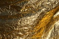 Texture of a thin crumpled sheet of foil. Crumpled foil background. Stock photo foil. Gold chrome color Royalty Free Stock Photo