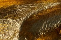 Texture of a thin crumpled sheet of foil. Crumpled foil background. Stock photo foil. Gold chrome color Royalty Free Stock Photo