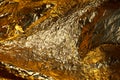 Texture of a thin crumpled sheet of foil. Crumpled foil background. Stock photo foil. Gold chrome color Royalty Free Stock Photo