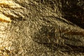 Texture of a thin crumpled sheet of foil. Crumpled foil background. Stock photo foil. Gold chrome color Royalty Free Stock Photo