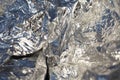 Texture of a thin crumpled sheet of foil. Crumpled foil background. Stock photo foil. Silver chrome color