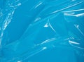 Texture of a transparent stretching plastic film for packaging products on a blue background Royalty Free Stock Photo