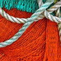 Texture Of A Red Green Fishing Net With A Robe Royalty Free Stock Photo