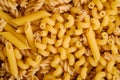 Texture of variety uncooked golden wheat pasta background