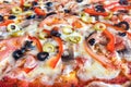 Texture of vegetarian pizza. Baked vegetables and olives. Back background. Royalty Free Stock Photo