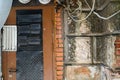 Texture of vintage brick wall with door and wires