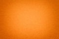 Texture of old orange paper background, closeup. Structure of dense cardboard