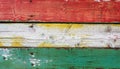 Texture of vintage wood boards with cracked paint of white, red, yellow and light green colo Royalty Free Stock Photo