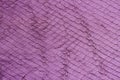 Texture of violet purple genuine leather close-up, with embossed scales reptiles, fashion trend background Royalty Free Stock Photo