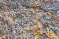 The texture of the wall is covered with gray-blue stucco interspersed with gold fragments Royalty Free Stock Photo