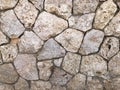 The texture of the wall is made of beautiful smooth, natural old, old, shuffled gray densely laid out without gaps, cobblestones, Royalty Free Stock Photo