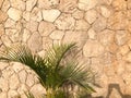 The texture of the wall is made up of beautiful natural old ancient shrewded yellow stones, cobblestones, masonry with uneven seam Royalty Free Stock Photo