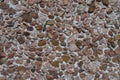 Texture of wall with multicolored gravel pebbledash Royalty Free Stock Photo