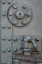 The texture of the wall of the tank, made of metal and reinforced with a multitude of bolts and rivets. Images of the covering of Royalty Free Stock Photo
