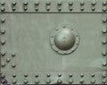 The texture of the wall of the tank, made of metal and reinforced with a multitude of bolts and rivets. Images of the covering of