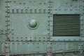 The texture of the wall of the tank, made of metal and reinforced with a multitude of bolts and rivets. Images of the covering of Royalty Free Stock Photo