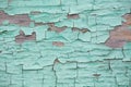 Texture of the wall of a wooden house with peeling green paint on a sunny day. Royalty Free Stock Photo