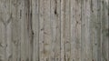 The texture of weathered wooden wall. Aged wooden plank fence of vertical flat board