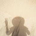 Texture of wet sand, surf. Women`s shadow on the sand, the girl in the hat Royalty Free Stock Photo
