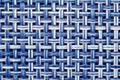Texture of white and blue synthetic fabric. Perpendicularly woven white and blue plastic threads. Abstract multitasking background Royalty Free Stock Photo