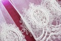 Texture of white decorative lace fabric with floral ornament on pink background Royalty Free Stock Photo