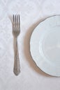 The texture on the white fabric. a linear pattern. White plate and fork. tableware Royalty Free Stock Photo