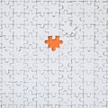 The texture of a white jigsaw puzzle in an assembled state with one missing element forming an orange space Royalty Free Stock Photo