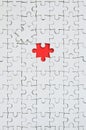 The texture of a white jigsaw puzzle in an assembled state with one missing element forming a red space Royalty Free Stock Photo