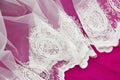 Texture of white lace fabric with floral ornament on pink background Royalty Free Stock Photo