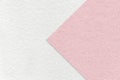 Texture of white paper background, half two colors with light pink arrow, macro. Structure of craft rose cardboard Royalty Free Stock Photo