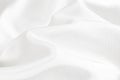 Texture of white satin or silk fabric with waves and rumples. white material