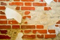 The texture of white stone concrete old battered red brick wall with cracks and exfoliated plaster, putty. The background Royalty Free Stock Photo