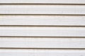 Texture of white wooden siding. Old wooden panels covered with d