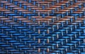 Texture of wicker furniture of rattan, blue orange rattan handmade texture with wavelike ornament