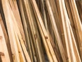 Texture of wooden brown diagonally tilted natural building boards sticks with knots. The background Royalty Free Stock Photo