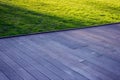 Texture of wooden outdoor floor with green grass.
