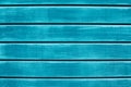 Texture of wooden planks with peeling turquoise blue color paint. Wooden fence texture. Old outdoor red wooden wall background pho Royalty Free Stock Photo