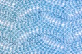 The texture of wool products close-up. Knitted zigzag pattern. Blank blue background.