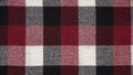 Texture of a woolen red-black-white plaid in a cage, close-up of fabric, textile winter background.Tartan fabric.Checkered pattern Royalty Free Stock Photo