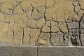 Texture of yellow concrete wall. Aged cement background. Fragment with scratches and cracks Royalty Free Stock Photo