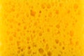 Texture yellow foam rubber, synthetic sponge with large pores, close-up background Royalty Free Stock Photo