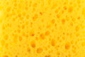 Texture yellow foam rubber, synthetic sponge with large pores, close-up background Royalty Free Stock Photo