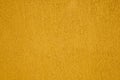 Texture of a yellow plastered wall as a background