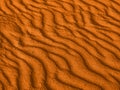 Texture of yellow red sand waves on the beach or in the desert. the ripples of the sand is diagonal. Royalty Free Stock Photo