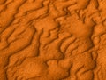 Texture of yellow red sand waves on the beach or in the desert. the ripples of the sand is diagonal. Royalty Free Stock Photo