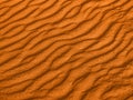 Texture of yellow red sand waves on the beach or in the desert. the ripples of the sand is diagonal. Royalty Free Stock Photo