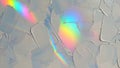 Textured abstract background with vibrant rainbow light reflections on a pale surface Royalty Free Stock Photo