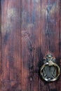 Textured, antique front door with forged handle Royalty Free Stock Photo